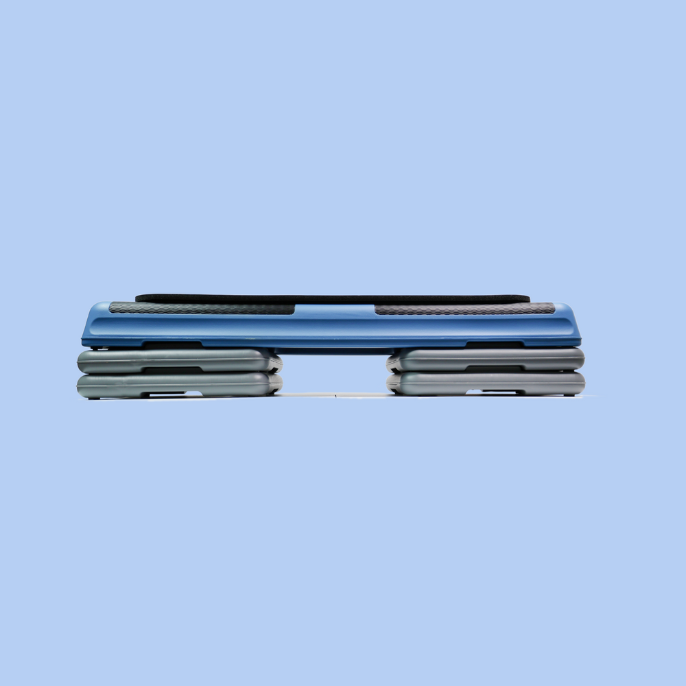 43" blue aerobic step  with 4 gray risers and a mini aerobic step mat for a woman's home gym