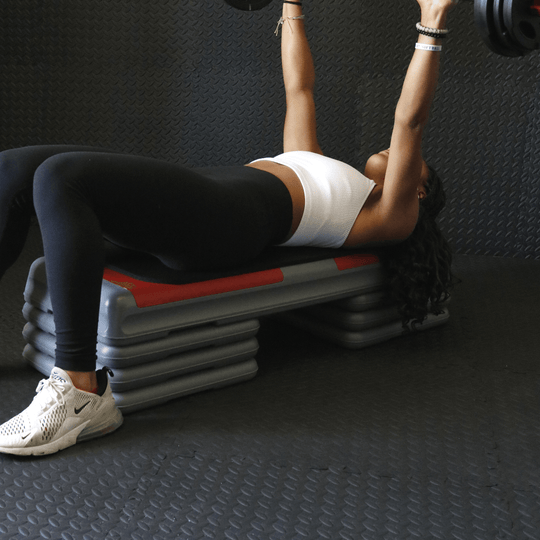 red aerobic step with 6 risers as a weight bench